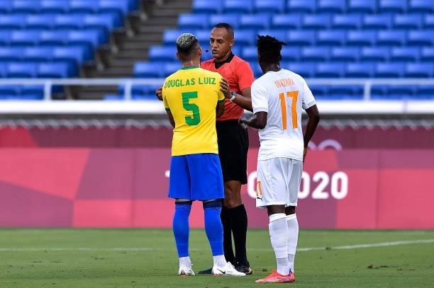 Douglas Luiz of Brazil, Referee Ismail Elfath of USA and Zie Ouattara of Ivory Coast during the Tokyo 2020 Olympic Mens Football Tournament match...
