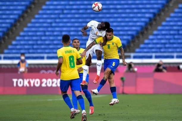 Youssouf Dao of Ivory Coast and Guilherme Arana of Brazil compete for the headed ball during the Tokyo 2020 Olympic Mens Football Tournament match...