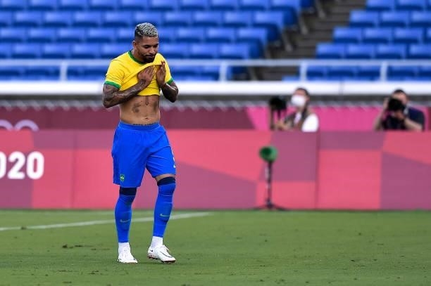 Douglas Luiz of Brazil leaves the pitch after receiving a red card during the Tokyo 2020 Olympic Mens Football Tournament match between Brazil and...