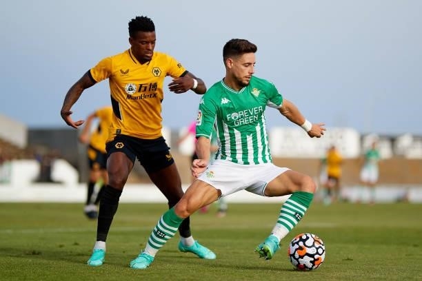 Alex Moreno of Real Betis competes for the ball with Nelson Semedo of Wolverhampton Wanderers during a Pre Season Friendly Match between Real Betis...