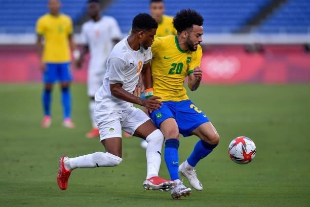 Amad Diallo of Ivory Coast and Claudinho of Brazil battle for possession during the Tokyo 2020 Olympic Mens Football Tournament match between Brazil...