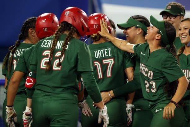 Anissa Urtez of Team Mexico is congratulated by teammates after hitting a two-run home run in the fifth inning against Team Italy during the Softball...