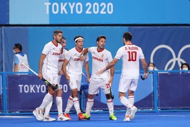 Enrique Gonzalez de Castejon of Team Spain celebrates with teammates after scoring their team's first goal during the Men's Preliminary Pool A match...