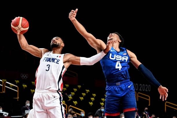 Timothe Luwawu Kongbo of France and Keldon Johnson of the USA challenge for the ball during the preliminary rounds of the Men's Basketball match...