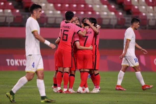 Donggyeong Lee of Team South Korea celebrates with teammates after scoring their side's second goal during the Men's Group match between Romania and...