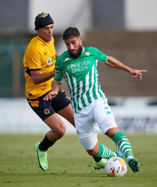 Nabil Fekir of Real Betis competes for the ball with Raúl Jiménez of Wolverhampton Wanderers during a Pre Season Friendly Match between Real Betis...