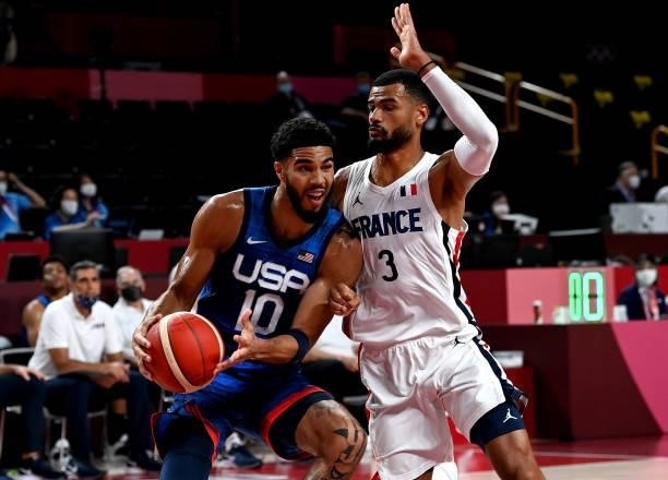 Jayson Tatum of the USA takes on the defence of Timothe Luwawu Kongbo of France during the preliminary rounds of the Men's Basketball match between...