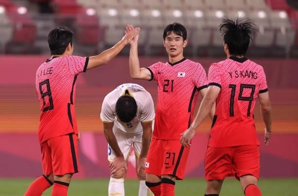 Kangin Lee of Team South Korea celebrates with teammate Jingyu Kim after scoring their side's fourth goal during the Men's First Round Group B match...
