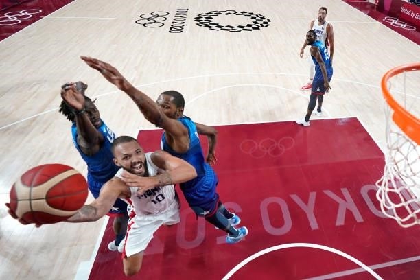 Evan Fournier of Team France drives past Kevin Durant of Team United States during the first half of the Men's Preliminary Round Group B game on day...