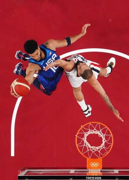 Jayson Tatum of Team United States drives to the basket against Evan Fournier of Team France during the first half of the Men's Preliminary Round...