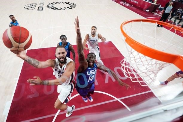 Evan Fournier of Team France drives past Draymond Green of Team United States during the first half of the Men's Preliminary Round Group B game on...