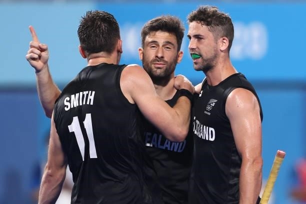 Kane Russell of Team New Zealand celebrates with teammates Jake Smith and Nick Wilson after scoring their team's third goal during the Men's...