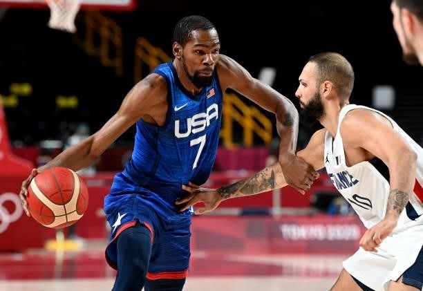 Kevin Durant of the USA takes on the defence of Evan Fournier of France during the preliminary rounds of the Men's Basketball match between the USA...