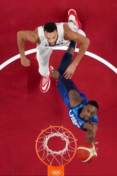 Bam Adebayo of Team United States drives past Rudy Gobert of Team France during the first half of the Men's Preliminary Round Group B game on day two...