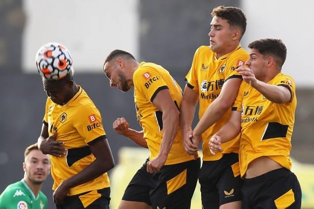 Yerson Mosquera headers the ball as he forms a wall alongside Romain Saiss, Maximilian Kilman and Christian Marques of Wolverhampton Wanderers during...