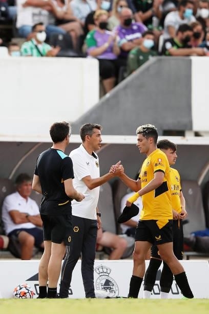 Raul Jimenez of Wolverhampton Wanderers shakes hands with Bruno Lage, Manager of Wolverhampton Wanderers after being substitutes off during the...