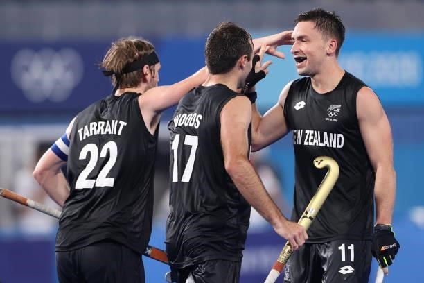Jake Smith of Team New Zealand celebrates with teammates Blair Tarrant and Nic Woods after scoring their team's fourth goal during the Men's...