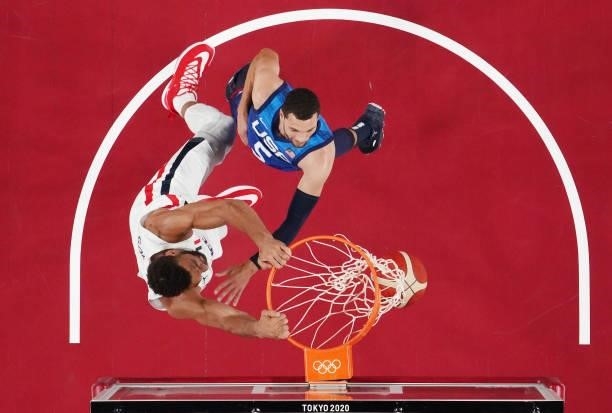 Rudy Gobert of Team France dunks over Zachary Lavine of Team United States during the first half of the Men's Preliminary Round Group B game on day...