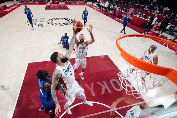 Vincent Poirier and Evan Fournier of Team France go up for a rebound against Team United States of America during the first half of the Men's...