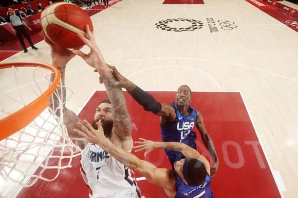 Vincent Poirier of Team France pulls down a rebound over Bam Adebayo of Team United States during the first half of the Men's Preliminary Round Group...
