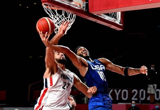 Jayson Tatum of the USA and Rudy Gobert of France challenge for the ball during the preliminary rounds of the Men's Basketball match between the USA...