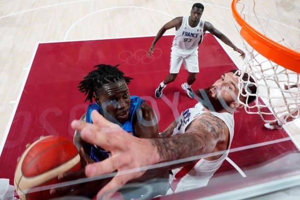 Jrue Holiday of Team United States drives to the basket against Vincent Poirier of Team France during the first half of the Men's Preliminary Round...