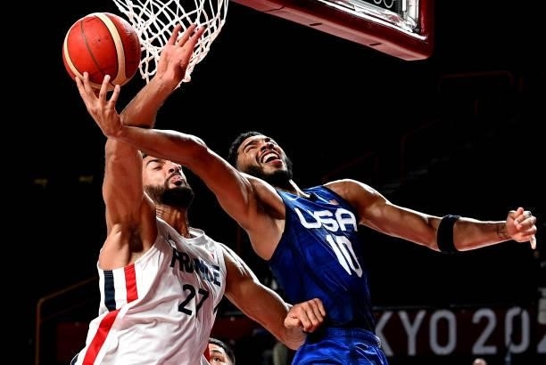 Jayson Tatum of the USA and Rudy Gobert of France challenge for the ball during the preliminary rounds of the Men's Basketball match between the USA...