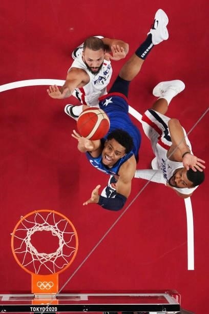 Keldon Johnson of Team United States drives to the basket against Evan Fournier and Timothe Luwawu Kongbo of Team France during the first half of the...