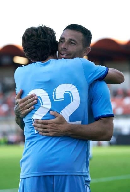 Ruben Castro of Cartagena celebrates after scoring his team's first goal with his teammate Delmas during the pre-season friendly match between...