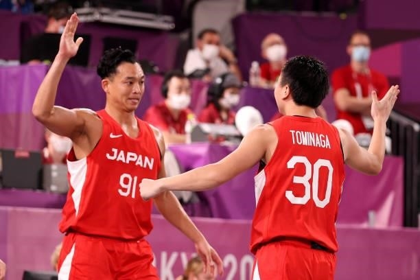 Keisei Tominaga of Team Japan celebrates a basket with Tomoya Ochiai of Team Japan during the Men's Pool Round match between Latvia and Japan on day...