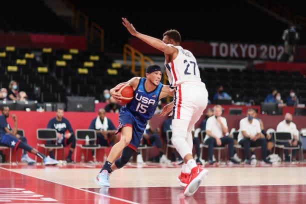 Devin Booker of Team United States drives to the basket against Rudy Gobert of Team France during the second half of the Men's Preliminary Round...