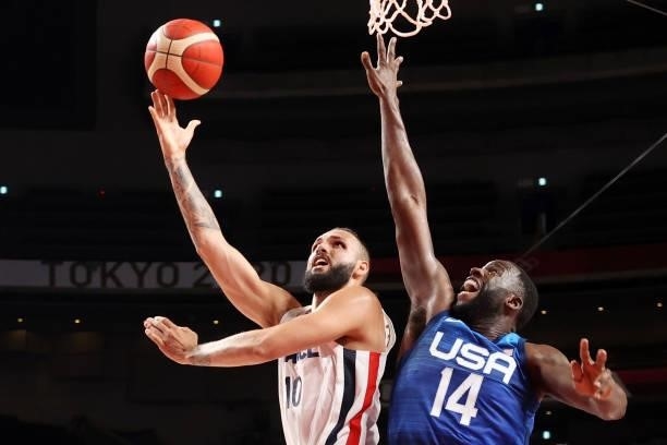Evan Fournier of Team France goes up for a shot over Draymond Green of Team United States during the second half of the Men's Preliminary Round Group...