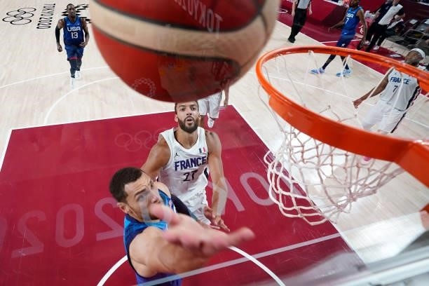 Zachary Lavine of Team United States drives past Rudy Gobert of Team France for a layup during the second half of the Men's Preliminary Round Group B...