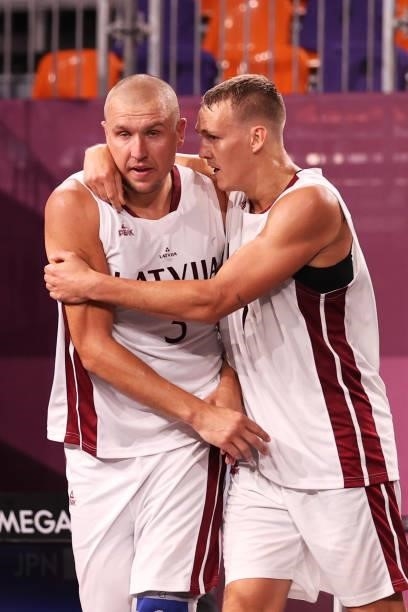 Edgars Krumins of Team Latvia celebrates victory with Nauris Miezis of Team Latvia after defeating Team Japan during the Men's Pool Round match...