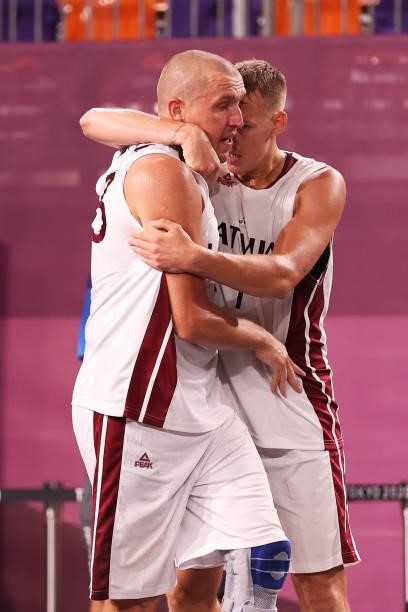 Edgars Krumins of Team Latvia celebrates victory with Nauris Miezis of Team Latvia after defeating Team Japan during the Men's Pool Round match...