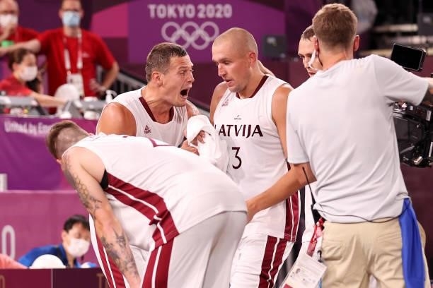 Edgars Krumins of Team Latvia celebrates victory with team mates after defeating Team Japan during the Men's Pool Round match between Latvia and...