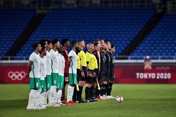 Saud Abdulhamid of Saudi Arabia, Yasir Al Shahrani of Saudi Arabia and Mohammed Al Yami of Saudi Arabia line up with their team mates during the...