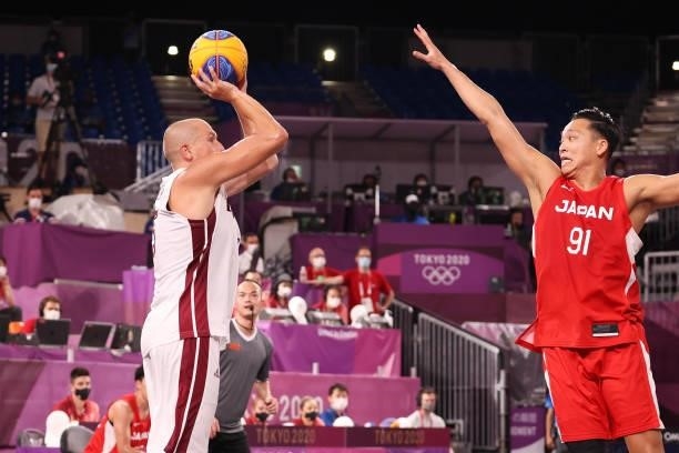 Edgars Krumins of Team Latvia shoots and hits the winning basket during the Men's Pool Round match between Latvia and Japan on day two of the Tokyo...