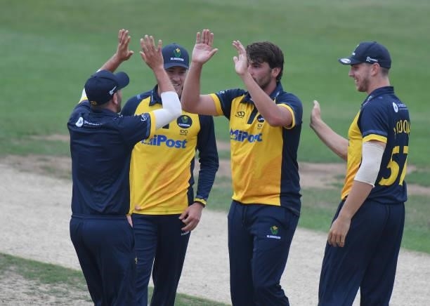 Lukas Carey of Glamorgan celebrates taking the wicket of Ricardo Vasconcelos of Northamptonshire during the Royal London Cup match between...