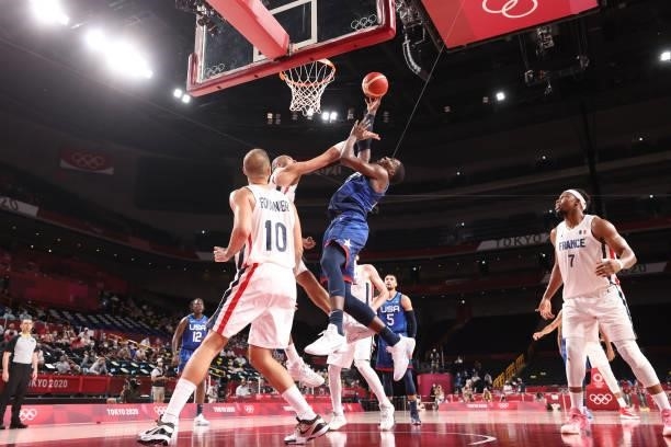 Bam Adebayo of Team United States drives to the basket against Nicolas Batum of Team France during the second half of the Men's Preliminary Round...
