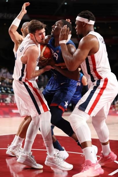 Bam Adebayo of Team United States fights for possession of the ball with Nando de Colo and Andrew Albicy of Team France during the second half of the...