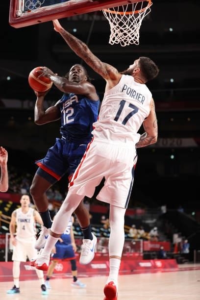 Jrue Holiday of Team United States drives to the basket against Vincent Poirier of Team France during the second half of the Men's Preliminary Round...