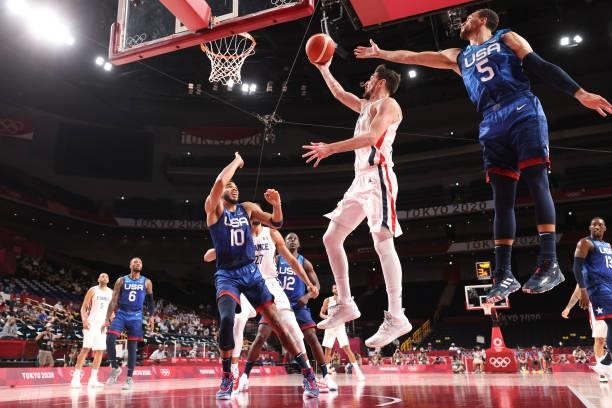 Nando de Colo of Team France drives into the lane for a layup against Zachary Lavine and Jayson Tatum of Team United States during the second half of...