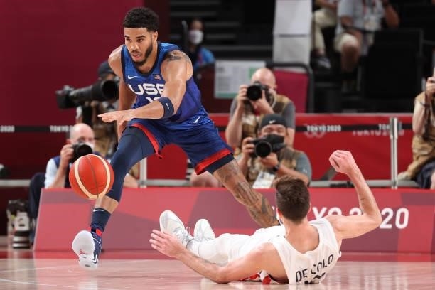Jayson Tatum of Team United States and Nando de Colo of Team France battle for possession of the ball during the first half of the Men's Preliminary...