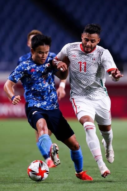 Kubo Takefusa of Japan competes for the ball with Vega Alexis of Mexico during the Men's First Round Group A match between Japan and Mexico on day...