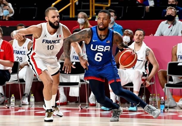 Damian Lillard of the USA breaks away from the defence of Evan Fournier of France during the preliminary rounds of the Men's Basketball match between...