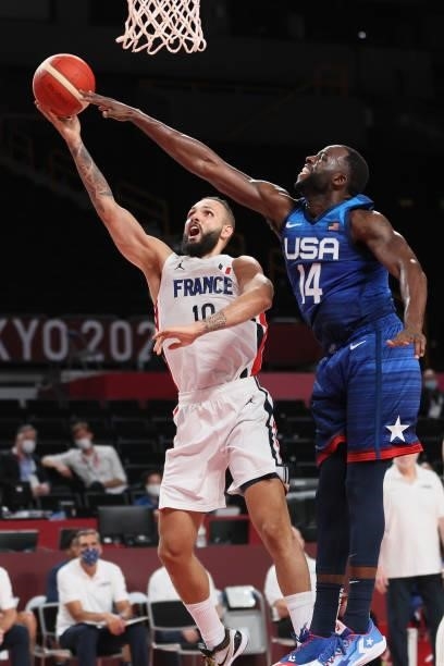 Evan Fournier of Team France drives to the basket against Draymond Green of Team United States during the second half of the Men's Preliminary Round...