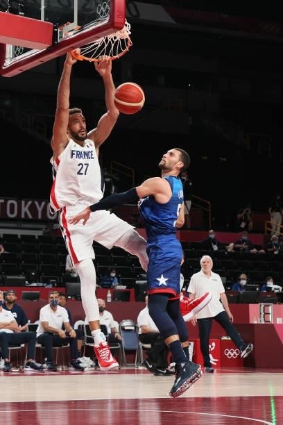 Rudy Gobert of Team France dunks over Zachary Lavine of Team United States during the second half of the Men's Preliminary Round Group B game on day...