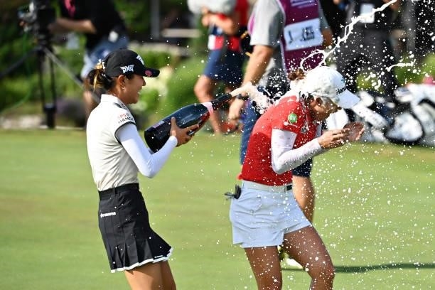 Tournament winner Minjee Lee of Australia celebrates with Lydia Ko of New Zealand on the eighteenth green during day four of the The Amundi Evian...