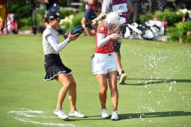 Tournament winner Minjee Lee of Australia celebrates with Lydia Ko of New Zealand on the eighteenth green during day four of the The Amundi Evian...
